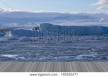 Opening wooden floor Ice on the lagoon with winter season landscape backgroiund Iceland