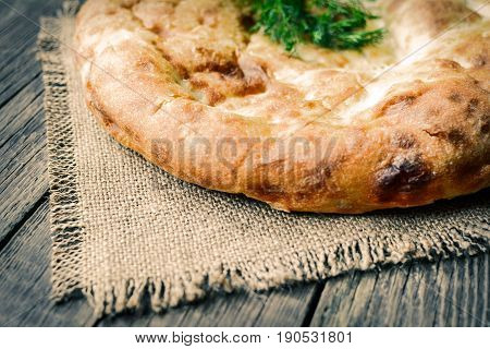Pita flatbread,. traditional asian bread on wooden background