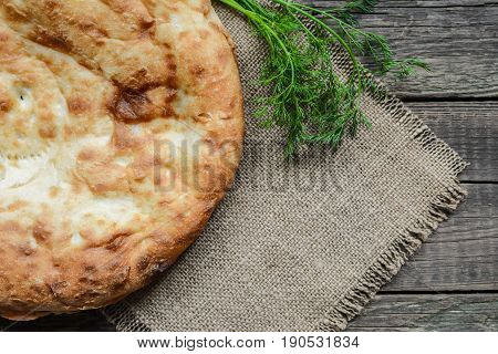 Pita flatbread,. traditional asian bread on wooden background
