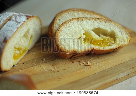 Cut pineapple pie with slices on a stripped cutting board. Close up