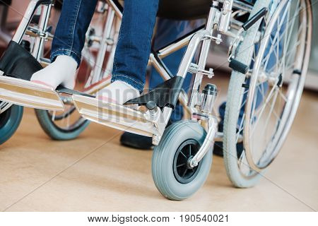 Disabled Kid on a Wheelchair Closeup Photo. Children Hospital Theme.