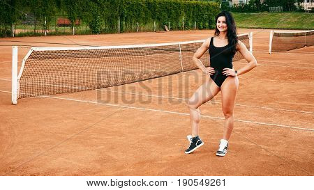 Beautiful Young Free Sports Sexy Fitness Girl Dressed In Bodysuit, Sneakers, With A Smart Ass And Lo
