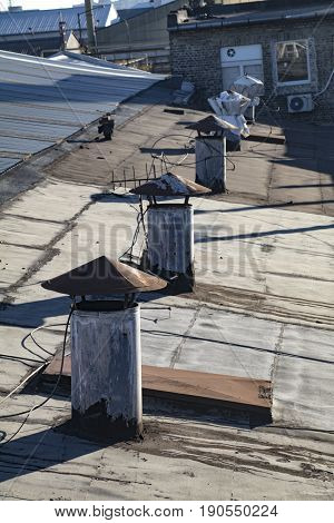 Chimneys on the roof of an old industrial facility