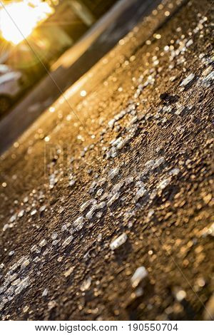 Pieces of broken glass sprayed across asphalt