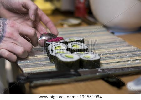 Maki Sushi With Cucumber And Caviar Is Being Prepared