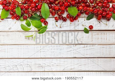 Fruit background cherry on wooden table. View from above with copy space