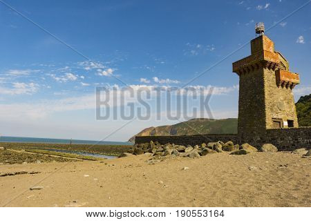 Lighthouse at the ocean's coast with blue sky