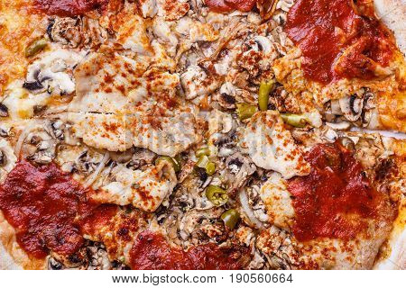 Junk fast food italian cuisine concept. Closeup of hot pizza. Delicious crusty unhealthy spicy meal.