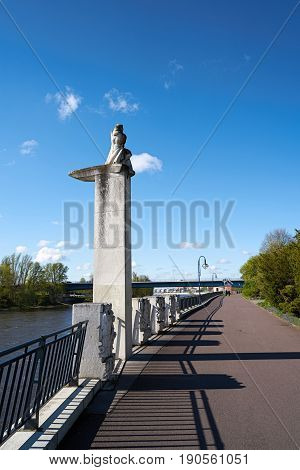 MAGDEBURG, GERMANY - APRIL 19, 2017: Promenade on the bank of the river Elbe in Magdeburg with the monument 