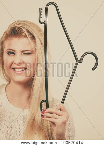 Blonde Woman Holding Clothes Hanger