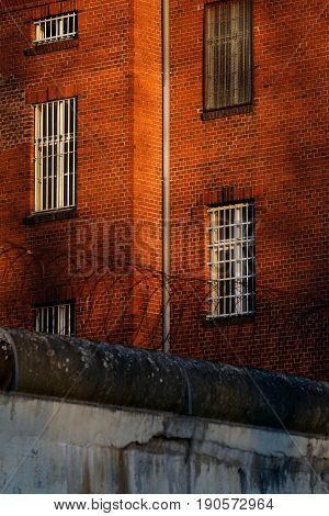 The outside view of an old and abandoned jail in Berlin during sunset