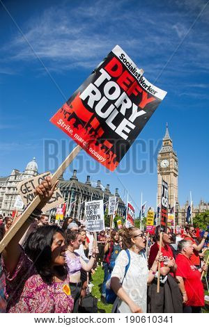 London, UK - June 10 2017: Unidentified protesters  at Westminster Palace expressing their anger at Theresa May's government and her alliance with the Democratic Unionist Party, London, UK