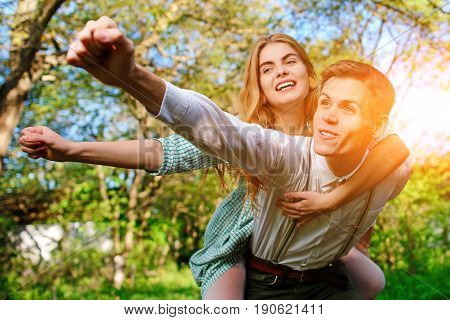 Portrait Of Happy Couple Raising Their Hands In Open Air