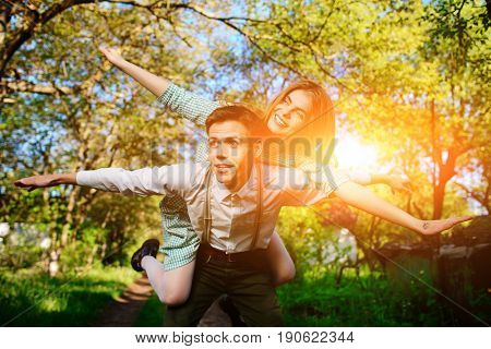 Portrait Of Happy Couple Raising Their Hands In Open Air