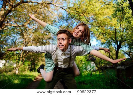 Portrait Of Happy Couple Raising Their Hands In Open Air