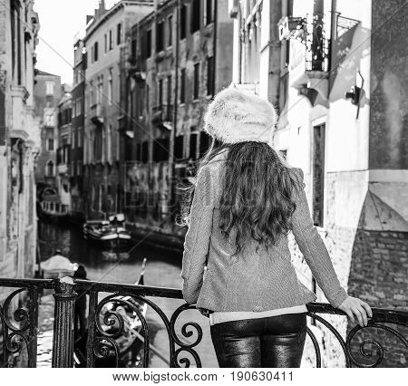 Seen From Behind Tourist Woman In Venice, Italy Having Excursion