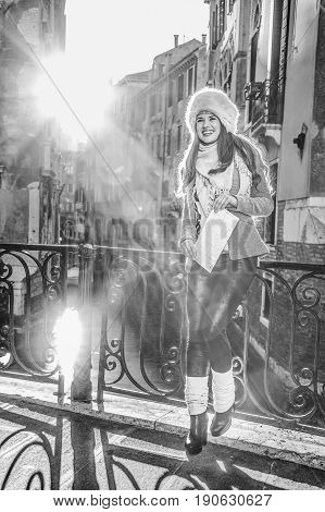 Happy Elegant Tourist Woman In Venice, Italy In Winter With Map