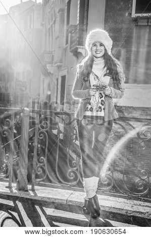 Smiling Tourist Woman In Venice, Italy In Winter Writing Sms