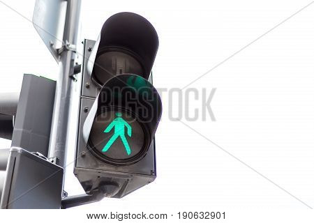 Traffic lights with the green light lit for pedestrians. Isolated on white background.