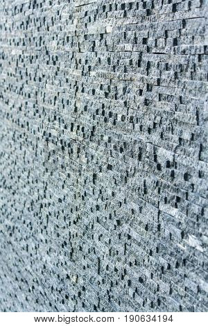 Dark grey stone tile dbrick wall backgrounf
