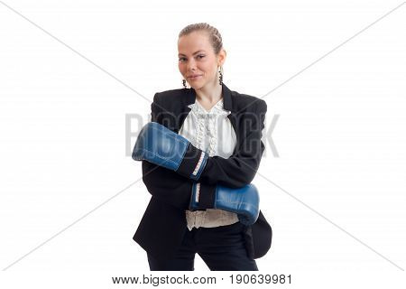 Beautiful blonde business woman in classic unifrom with blue boxing gloves smiling on camera isolated on white background