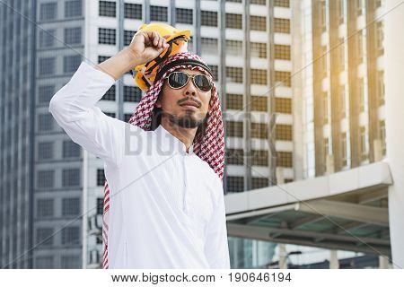 Arab Engineer construction worker holding helmet construction