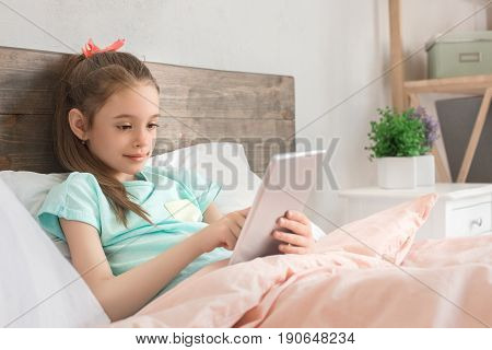 Young teenager girl alone at home childhood using digital device