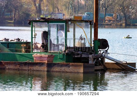 Dredger Floating excavator when dredging of soil sand and silt from a river.