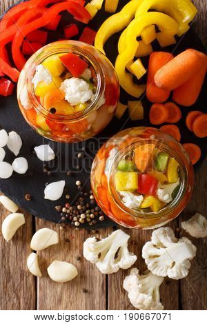 Giardiniera Salad From Pickled Cauliflower, Pepper And Carrots Close-up In Glass Jars. Vertical Top