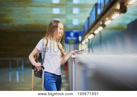 Traveler With Backpack In International Airport At Check-in Counter