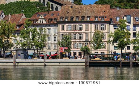 Schaffhausen, Switzerland - 29 August, 2015: buildings along the Rhine river people on the embankment of the river. Schaffhausen is a city in northern Switzerland, it is the capital of the Swiss canton of Schaffhausen.
