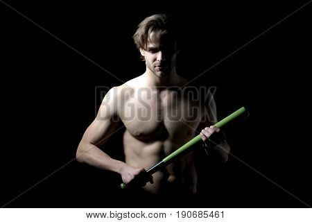 man athlete or bodybuilder with fit muscular naked torso belly six pack ab chest holding baseball bat in strong hands triceps biceps on black background. Sport and training