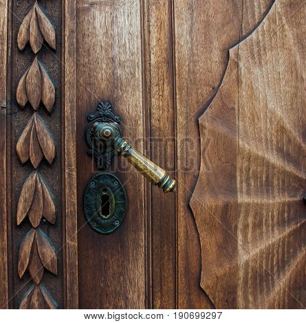 Old wooden door with iron handle on the Prešeren square in Ljubljana, Slovenia - Jun 2017