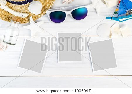 Summer Beach accessories (White sunglassesstarfishstraw hatshell) and photo paper frame on white plaster wood table top viewSummer vacation conceptLeave space for adding your photo.