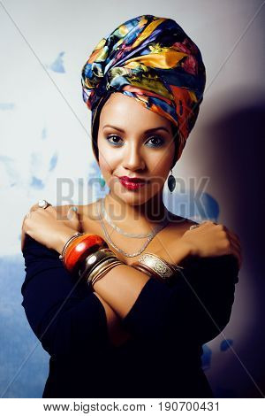 beauty bright real african woman with creative make up, shawl on head like cubian closeup smiling