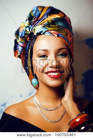 beauty bright real african woman with creative make up, shawl on head like cubian closeup smiling