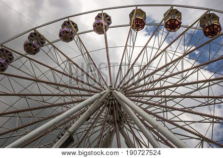 Big ferris wheel on the cloudy sky