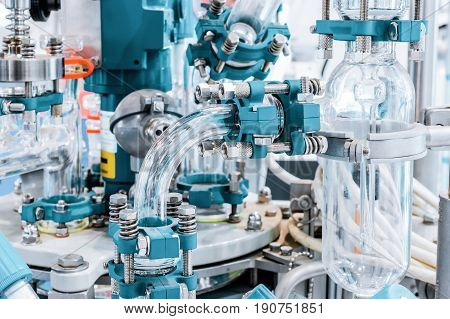 Fragment of chemical reactor equipment, glass pipe. Abstract industrial background.