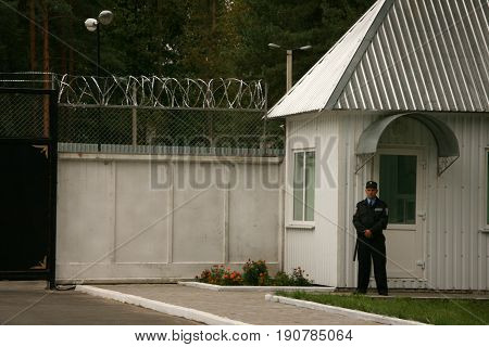 ZHURAVYCHI UKRAINE - 12 September 2008: Male security guard standing at the entrance of control checkpoint of temporary residence of foreigners and stateless persons who illegally stay in Ukraine