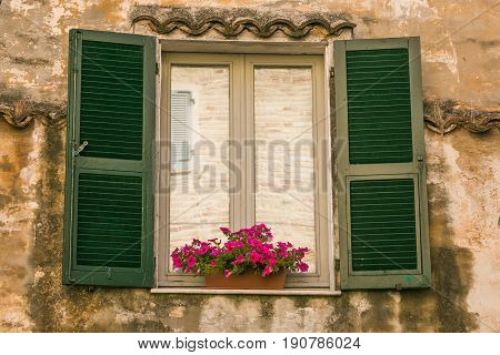 Window of old palace in the medieval center Grottammare