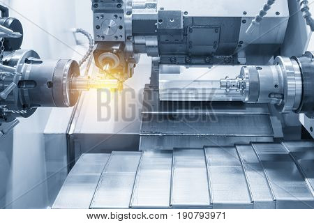 The CNC lathe machine or Turning machine drilling the metal rod with the drill tool and center drill tool .The hi-technology machining concept.