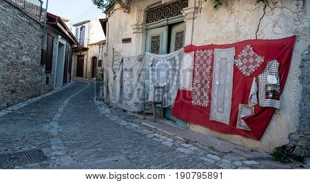 Lefkara Cyprus - August 21 2016: Handmade lace called lefkaritika hanging on the wall of a house at Lefkara village Larnaca district Cyprus