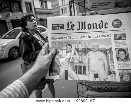 PARIS FRANCE - JUN 12 2017: Man point of view personal perspective buying at press kiosk French newspaper Le Wonde with reactions to French legislative election 2017 a day after first round