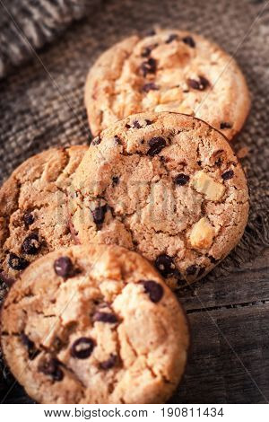 Chocolate chip cookies on dark old wooden table with place for text. freshly baked. Selective Focus with Copy space.