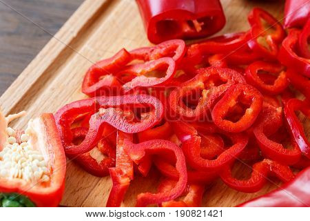 Sweet Red Pepppers On A Wooden Board