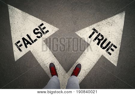 TRUE versus FALSE written on the white arrows dilemmas concept.