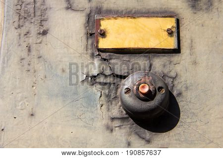 Old vintage door bell button on grunge wall Antique door bell.