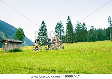 family of four cycling by the vilsalpsee in austria