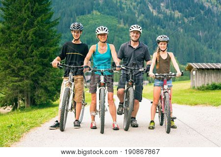 family of four cycling by the vilsalpsee in austria