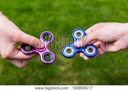 Kid hands with popular toy fidget spinners